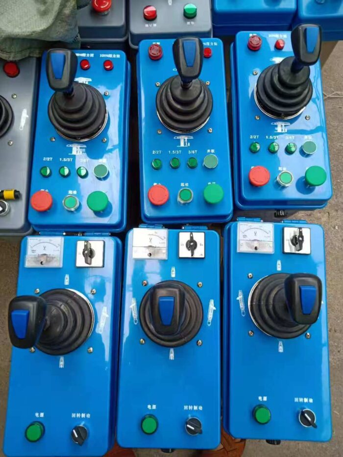 Crane control desk with emergency stop and voltmeter